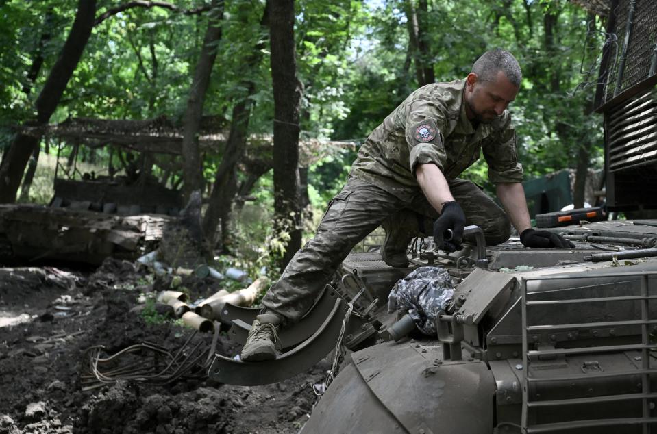 A Ukrainian serviceman fixes a T-72 tank in Donetsk, Ukraine (AFP via Getty Images)