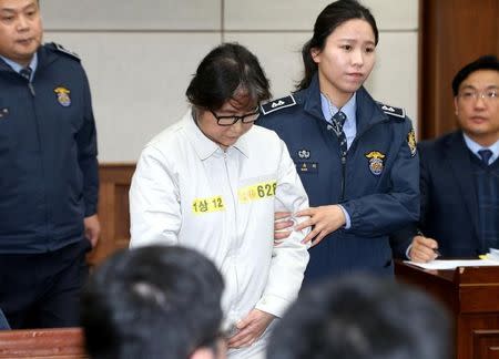 Choi Soon-sil, a long-time friend of South Korean President Park Geun-hye who is at the center of the South Korean political scandal involving Park, arrives for her first court hearing in Seoul, South Korea, December 19, 2016. Korea Pool/via REUTERS