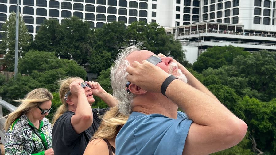 Folks watch the total solar eclipse from the Congress Avenue bridge in Austin, Texas, on April 8. (KXAN Photo/Andy Way)