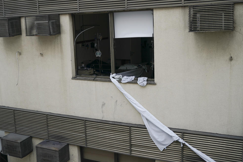 A rope made of bedsheets that was used to escape from the upper floor of the Badim Hospital, is seen tied to a window, where a fire left at least 11 people dead, in Rio de Janeiro, Brazil, Friday, Sept. 13, 2019. The fire raced through the hospital forcing staff to wheel patients into the streets on beds or in wheelchairs. (AP Photo/Leo Correa)