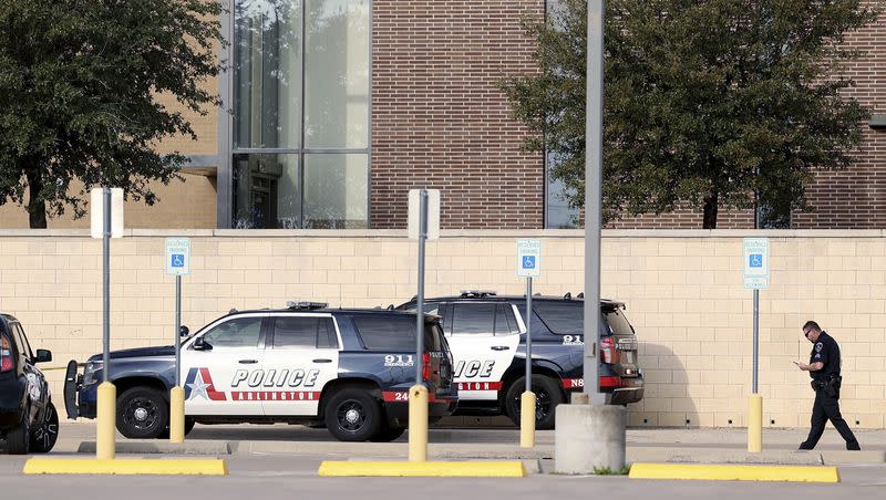 Arlington police investigate a shooting at Lamar High School in Arlington, Texas, on Monday, March 20, 2023. The school is under lockdown after two students were injured in the shooting.