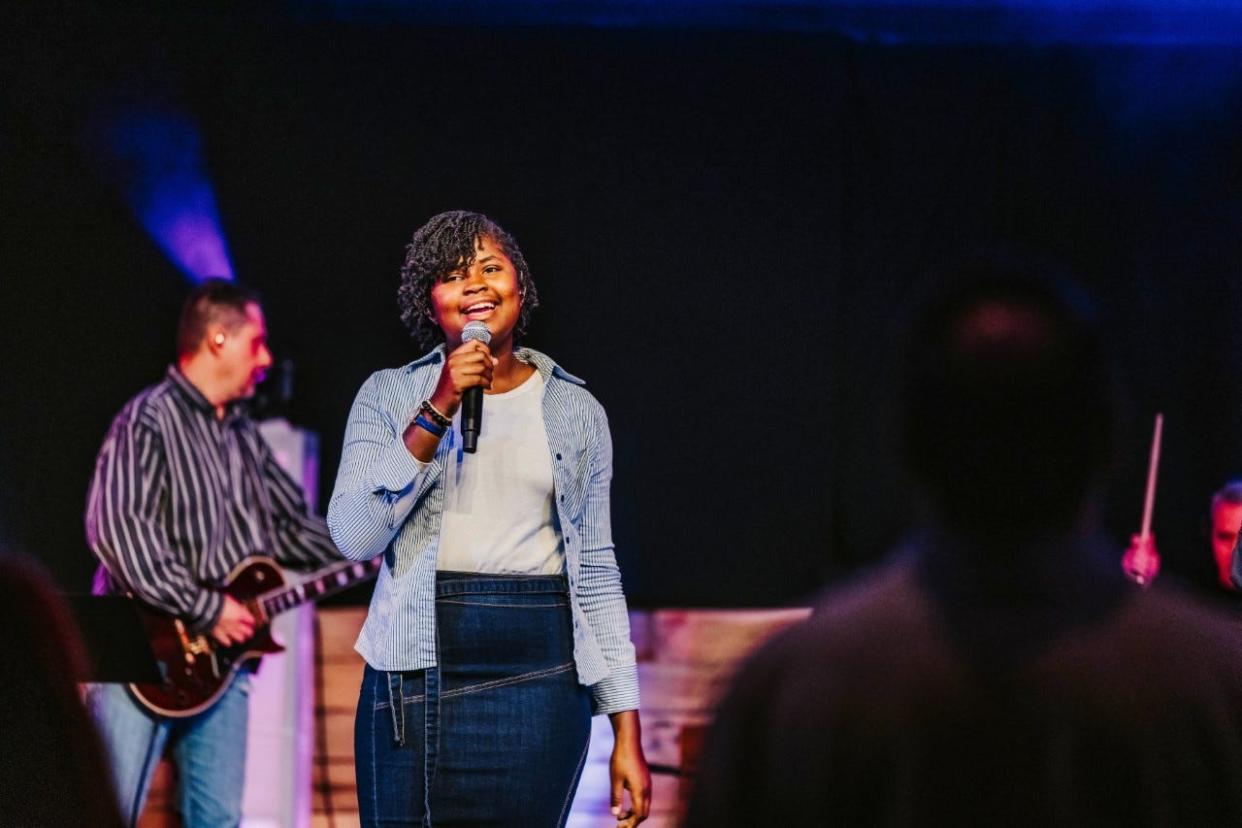 Malone University student Elischamma "El G" Belade of Haiti is part of the worship team at Cross Pointe Church in Canton, which created a scholarship to help her and several other Malone students to stay in school.