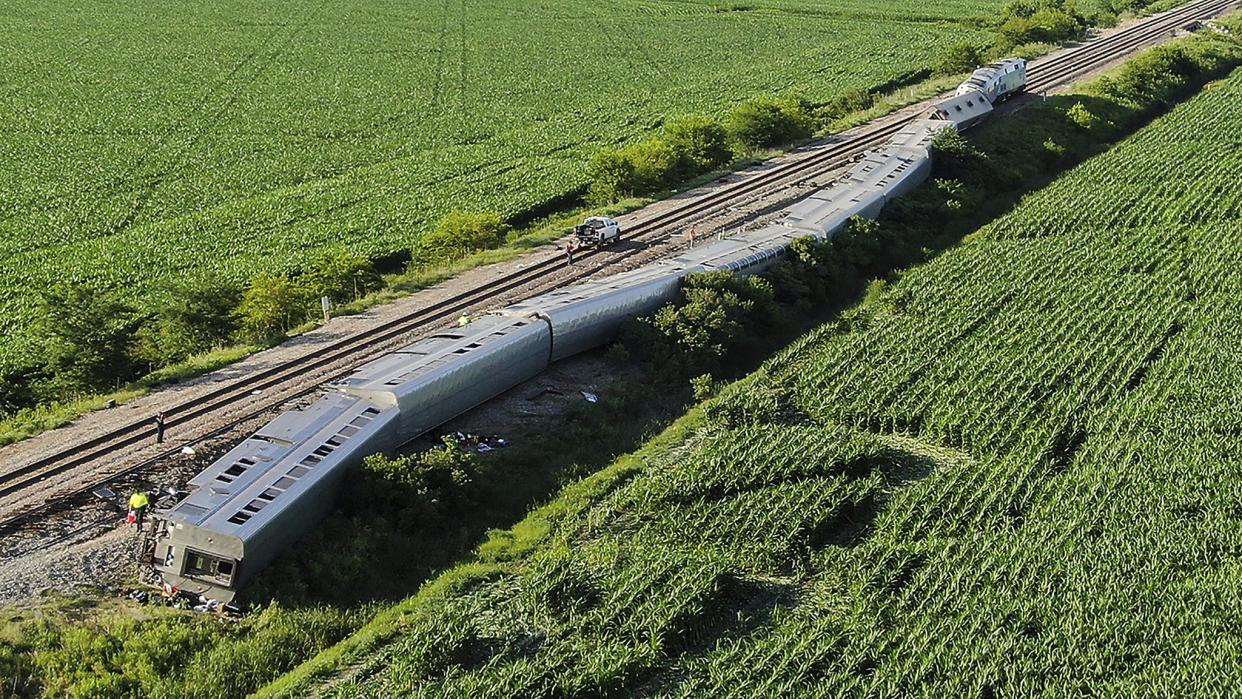 The Amtrak train lies on its side after derailing.