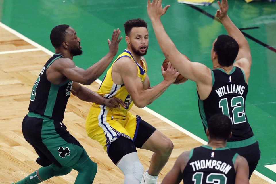 Boston Celtics' Kemba Walker (8) and Grant Williams (12) defend against Golden State Warriors' Stephen Curry, center, during the first half of an NBA basketball game, Saturday, April 17, 2021, in Boston. (AP Photo/Michael Dwyer)