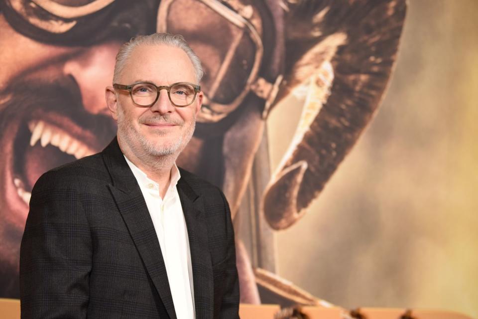 francis lawrence, a grey haired filmmaker in light brown coloured glasses, smiling at the camera