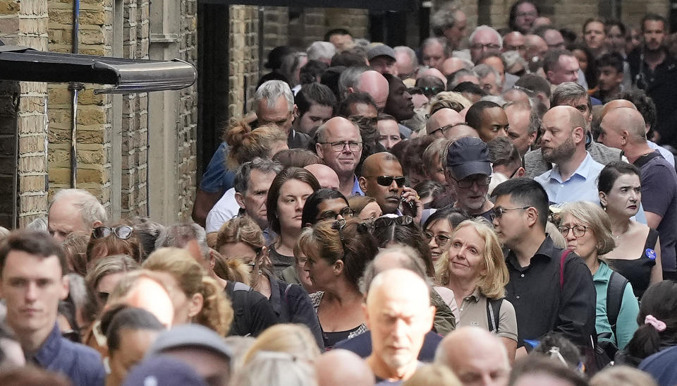 People queue before the start of the more than four miles long line near Tower Bridge to pay their respect to the late Queen Elizabeth II during the Lying-in State, in Westminster Hall in London, Thursday, Sept. 15, 2022. The Queen will lie in state in Westminster Hall for four full days before her funeral on Monday Sept. 19. (AP Photo/Martin Meissner)