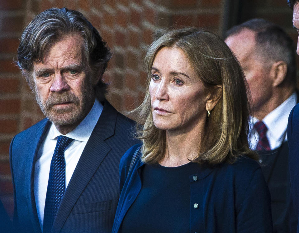 Felicity Huffman and her husband, William H. Macy, walk out of the federal courthouse in Boston on Sept. 13, 2019.
