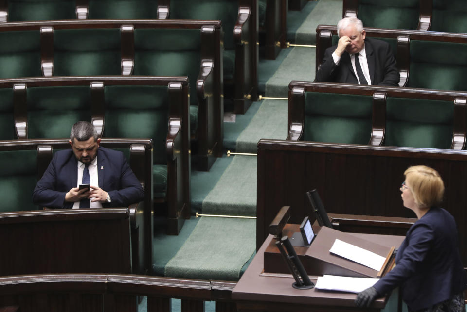 Jaroslaw Kaczynski, leader of the conservative ruling party Law and Justice, second row right, takes part in a parliamentary session in Warsaw, Poland, Friday, April 3, 2020. Uncertainty deepened in Poland on Friday over whether the country will move forward with a presidential election scheduled for May despite the coronavirus pandemic. Kaczynski had hoped to move forward with the vote despite the epidemic by having a postal election, but the head of a faction in his coalition is opposed and wants the elections postponed by two years.(AP Photo/Czarek Sokolowski)