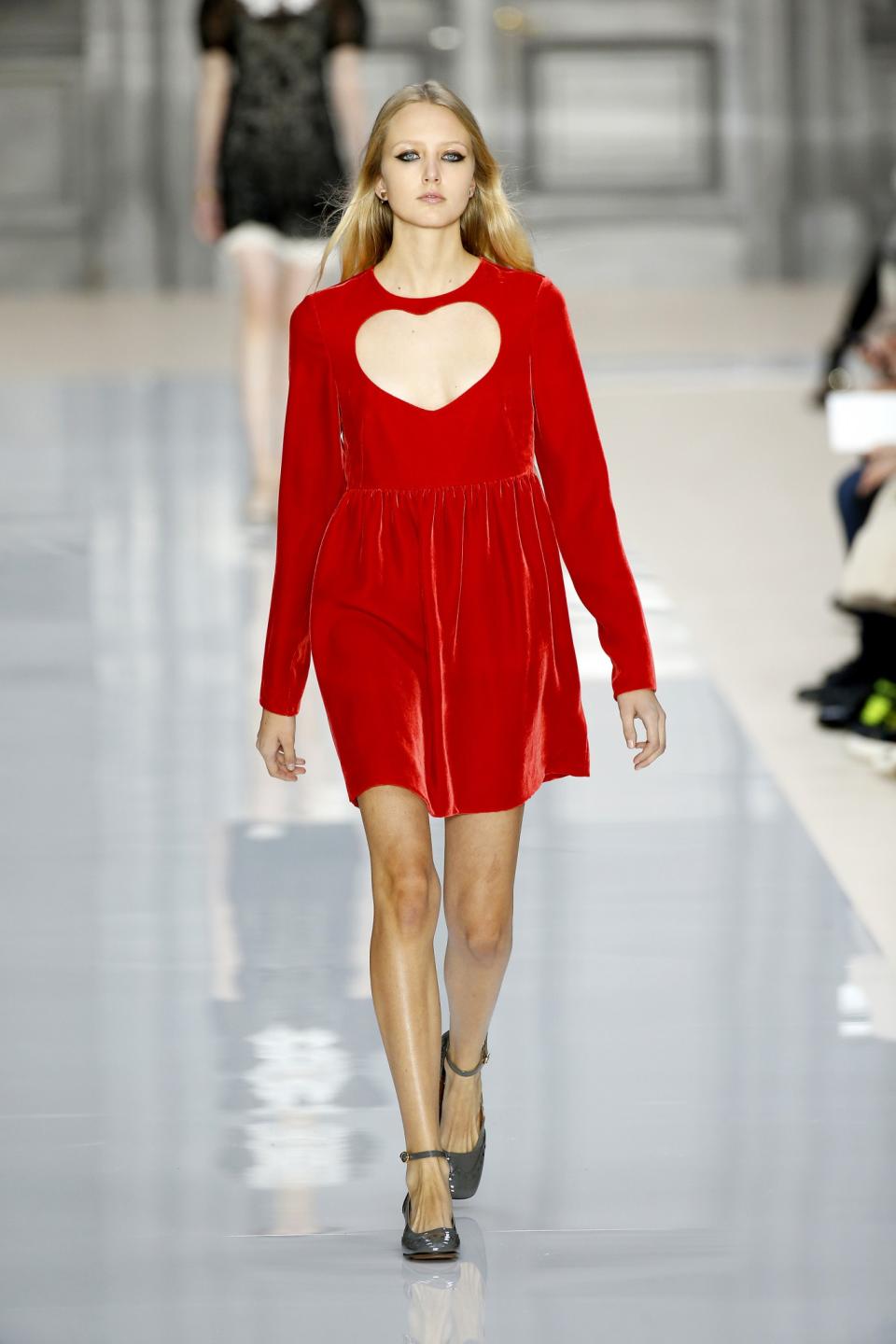 Model wears a red dress with heart cut-out silhouette across the chest at the Chloé Fall/Winter 2017 show