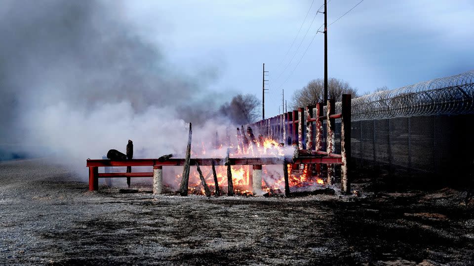 Lumber burns in a storage yard after the Smokehouse Creek Fire ravages Canadian, Texas. - Nick Oxford/Reuters