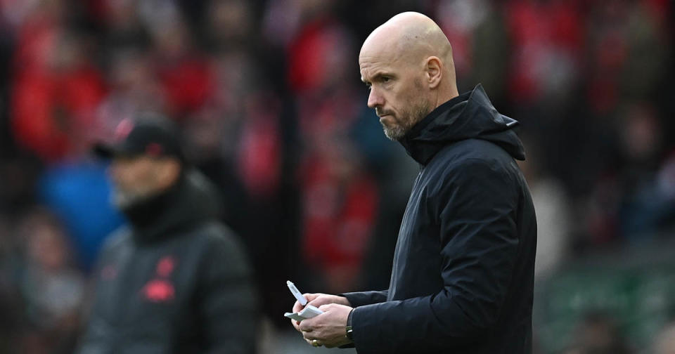 Manchester United manager Erik ten Hag makes notes during the English Premier League football match between Liverpool and Manchester United at Anfield in Liverpool, north west England on March 5, 2023.