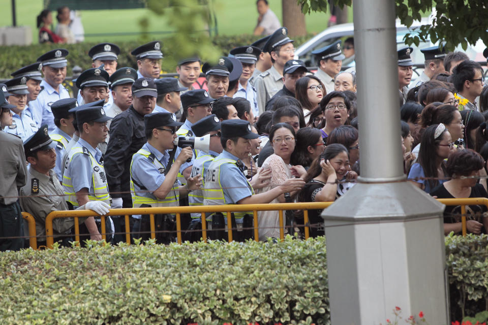 Police officers remove fans standing outside the opening ceremony of the 17th Shanghai International Film Festival, June 14, 2014. REUTERS/Aly Song  (CHINA - Tags: ENTERTAINMENT)