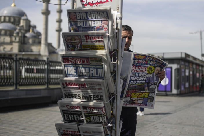 A man reads a Turkish newspaper a day after the presidential election day, in Istanbul, Turkey, Monday, May 15, 2023. Turkey's presidential elections appeared to be heading toward a second-round runoff on Monday, with President Recep Tayyip Erdogan, who has ruled his country with a firm grip for 20 years, leading over his chief challenger, but falling short of the votes needed for an outright win. (AP Photo/Emrah Gurel)