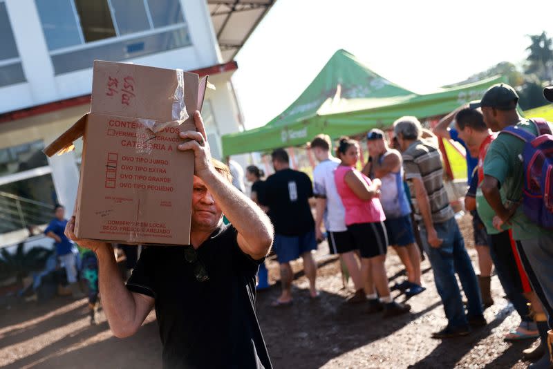 People line up for water and food donation in Roca Sales in Rio Grande do Sul state