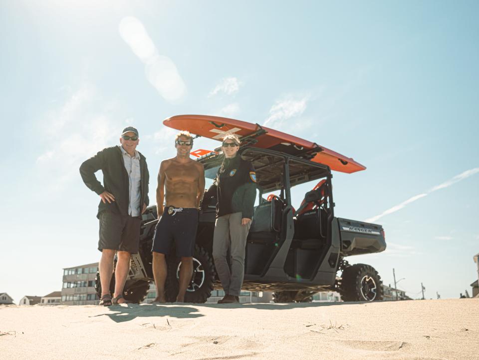 Tom Richardson (left), host of "Explore New England," with Hampton Beach lifeguard Chief Patrick Murphy and State Parks Seacoast Regional Supervisor Meredith Collins filming an episode of Richardson's show on recreation at Hampton Beach.