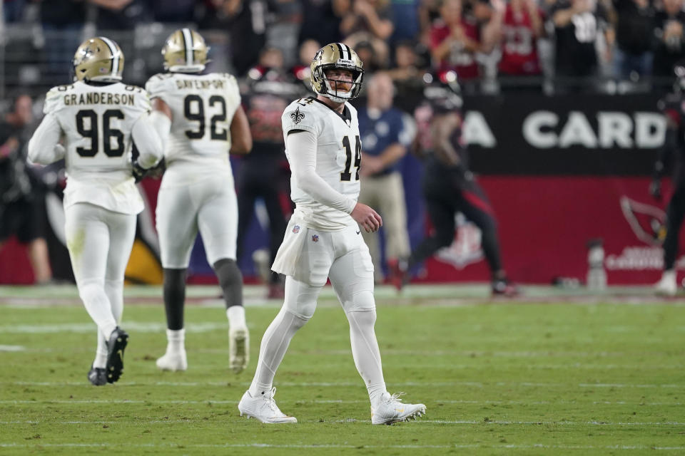 New Orleans Saints quarterback Andy Dalton (14) reacts after throwing his second interception that was returned for a touchdown, during the first half of an NFL football game against the Arizona Cardinals, Thursday, Oct. 20, 2022, in Glendale, Ariz. (AP Photo/Matt York)