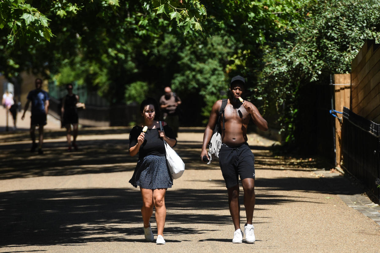 LONDON, ENGLAND  - JUNE 25: People are seen eating ice creams on June 25, 2020 in London, United Kingdom. The UK is experiencing a summer heatwave, with temperatures in many parts of the country expected to rise above 30C and weather warnings in place for thunderstorms at the end of the week. (Photo by Peter Summers/Getty Images)