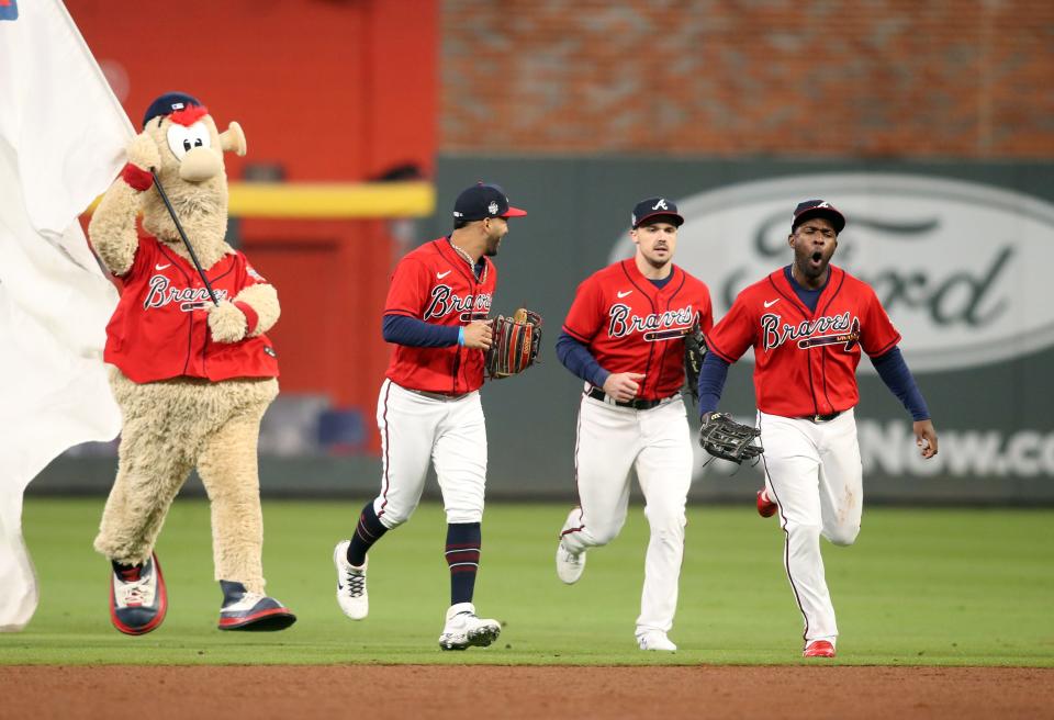 Game 3: Braves players celebrate on the field after the win.