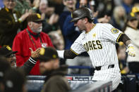 San Diego Padres' Jackson Merrill is congratulated after hitting a solo home run during the third inning of a baseball game against the St. Louis Cardinals, Monday, April 1, 2024, in San Diego. (AP Photo/Denis Poroy)