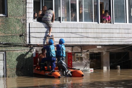 Rescue workers help residents after Typhoon Lekima hit the city of Linhai