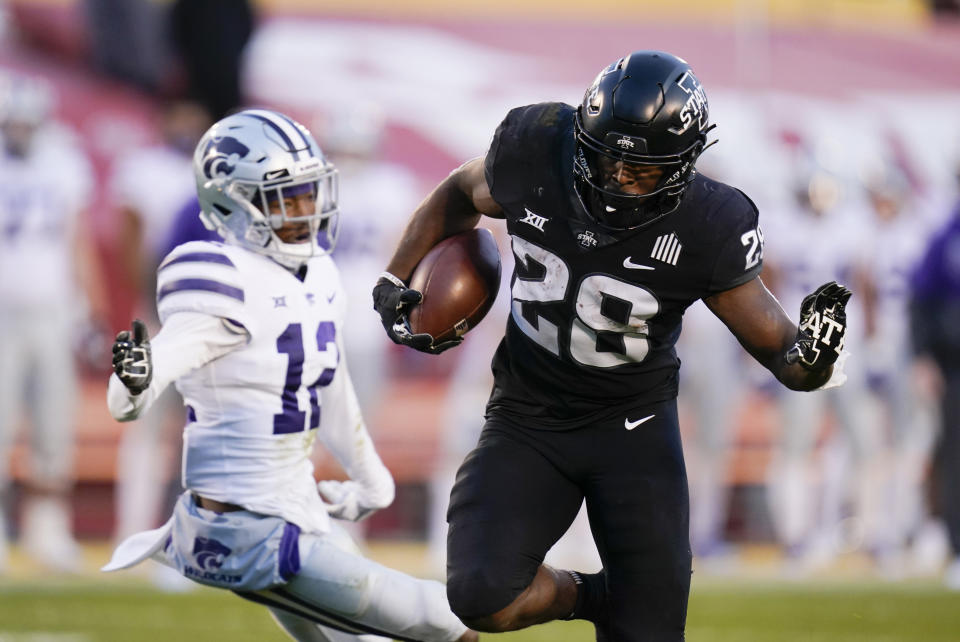 Iowa State running back Breece Hall (28) scores on a 21-yard touchdown run ahead of Kansas State defensive back AJ Parker (12) during the first half of an NCAA college football game, Saturday, Nov. 21, 2020, in Ames, Iowa. (AP Photo/Charlie Neibergall)