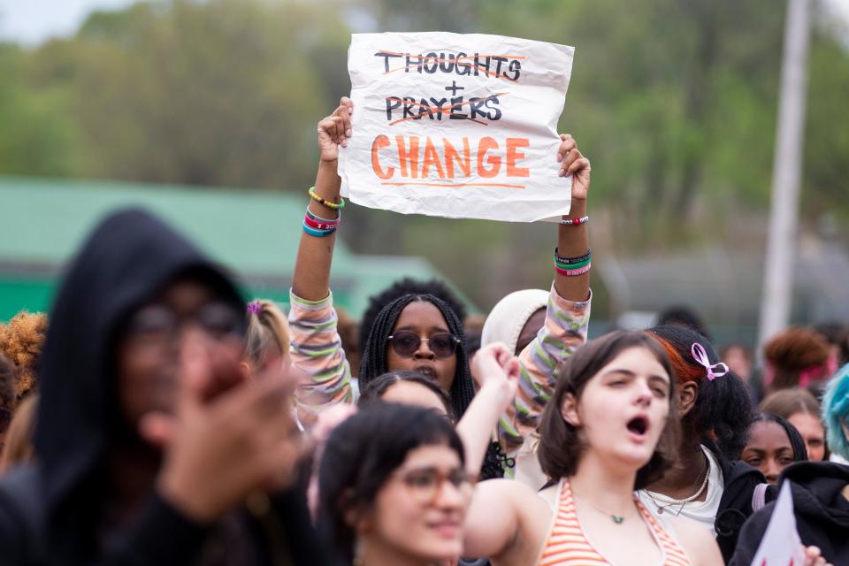 Students chant and hold up signs during a “Walkout to End Gun Violence” event outside White Station High School hosted by Students Demand Action in Memphis, Tenn., on Wednesday, April 5, 2023. The walkout comes a week after the school shooting at The Covenant School in Nashville that left six dead, including three students. 