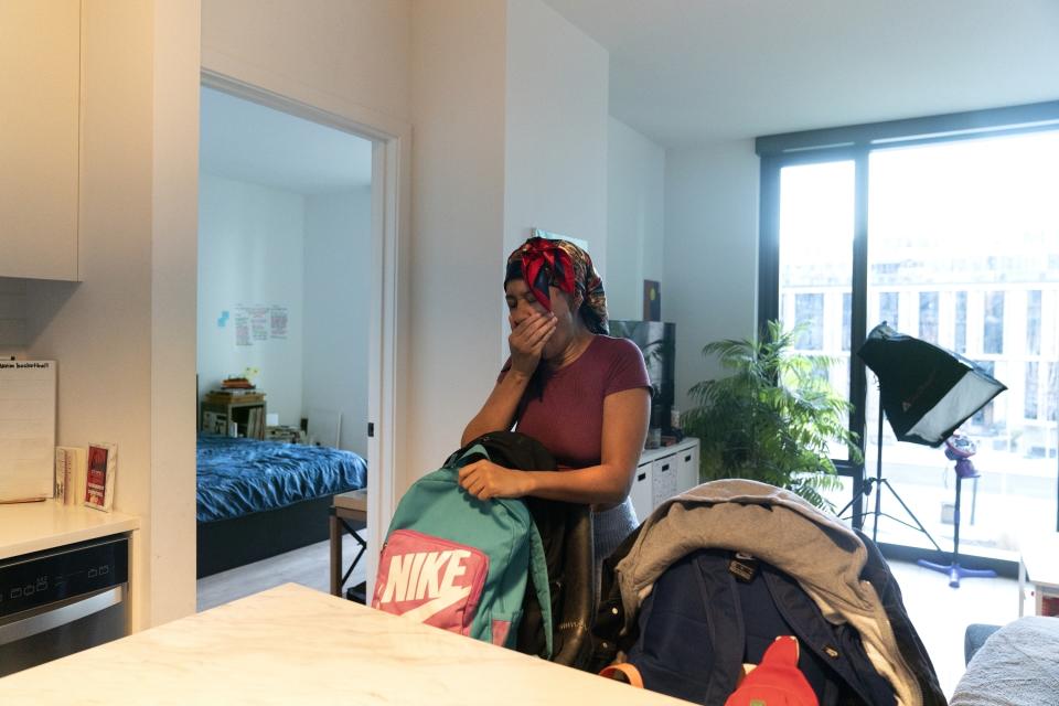 Johnae Strong yawns as she prepares lunches, backpacks and clothing for her 10-year-old son and 6-year-old daughter as they ready for school and work Friday, Feb. 10, 2023, in Chicago. (AP Photo/Erin Hooley)