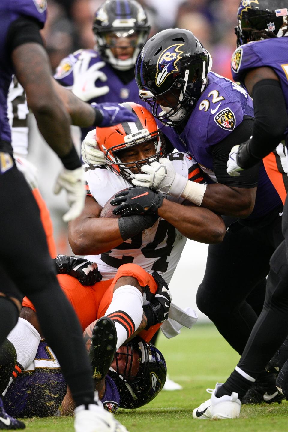 Cleveland Browns running back Nick Chubb (24) is stopped Baltimore Ravens defensive tackle Justin Madubuike (92) in the second half of an NFL football game, Sunday, Oct. 23, 2022, in Baltimore. (AP Photo/Nick Wass)