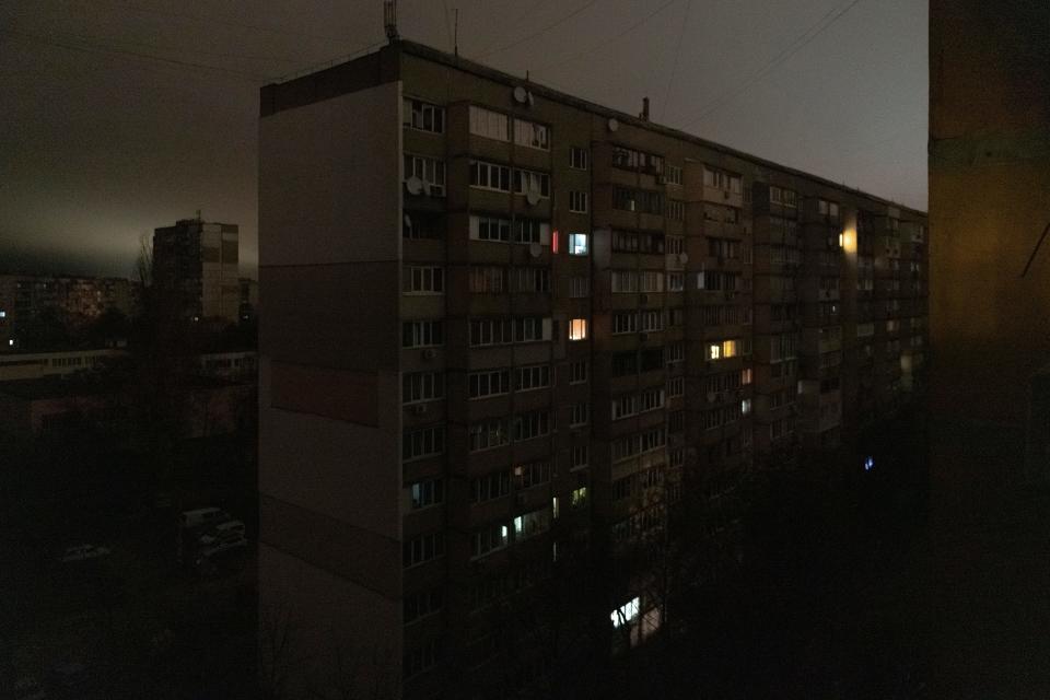 Windows of an apartment building are illuminated during a blackout in central Kyiv, Ukraine, Monday, Nov. 14, 2022. (AP Photo/Andrew Kravchenko) ORG XMIT: XB101