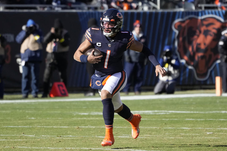 Chicago Bears' Justin Fields runs during the first half of an NFL football game against the Philadelphia Eagles, Sunday, Dec. 18, 2022, in Chicago. (AP Photo/Charles Rex Arbogast)