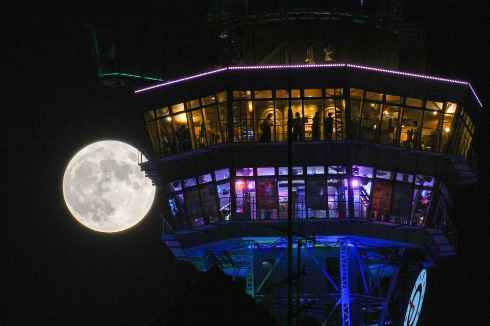 A full moon is seen behind Osaka's landmark Tsutenkaku Towe