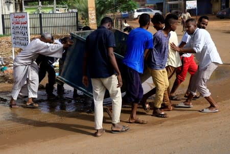 Sudanese protesters erect a barricade on a street and demanding that the country's Transitional Military Council hand over power to civilians in Khartoum