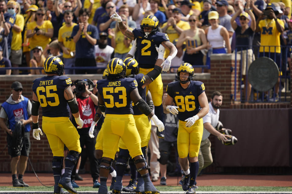 Michigan running back Blake Corum (2) celebrates his 20-yard touchdown run against Connecticut in the first half of an NCAA college football game in Ann Arbor, Mich., Saturday, Sept. 17, 2022. (AP Photo/Paul Sancya)