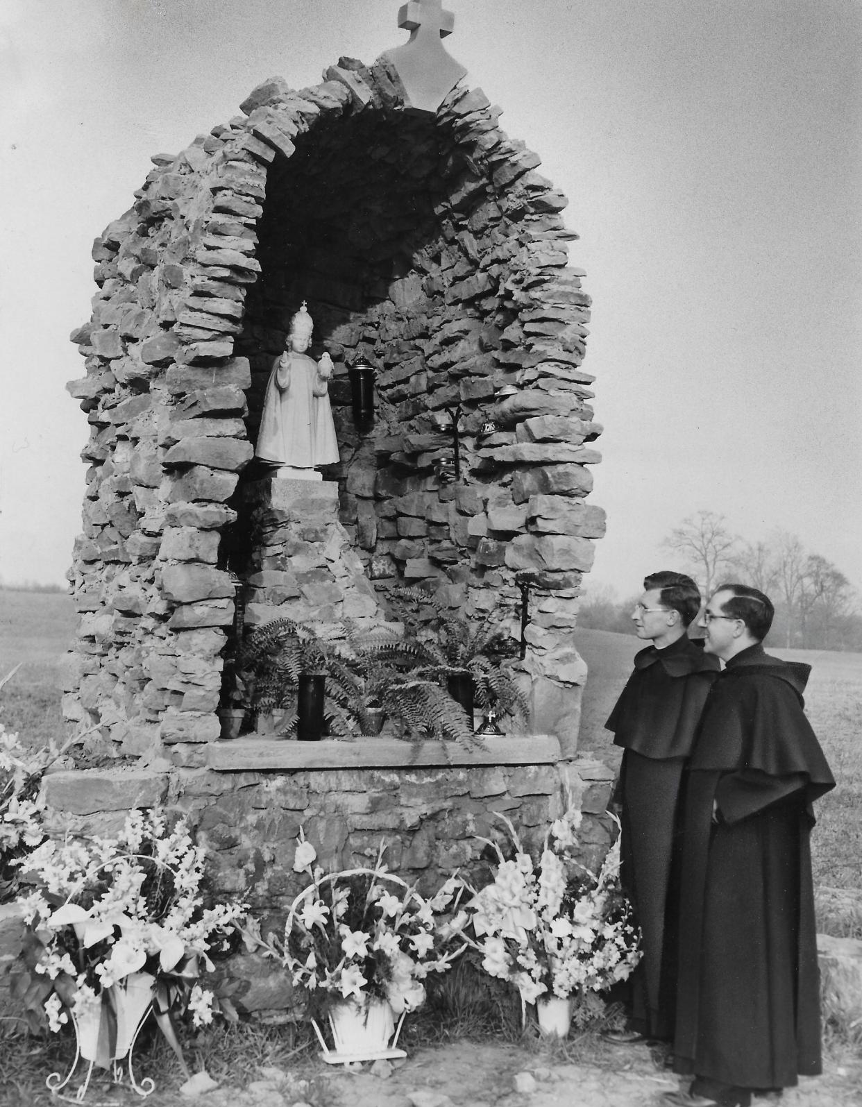 The Rev. Alphonsus Croake and the Rev. Mario Dittami admire a new shrine in 1951 at Infant of Prague Villa in Coventry Township. The structure was built with stones from the foundation of an old barn on the property.