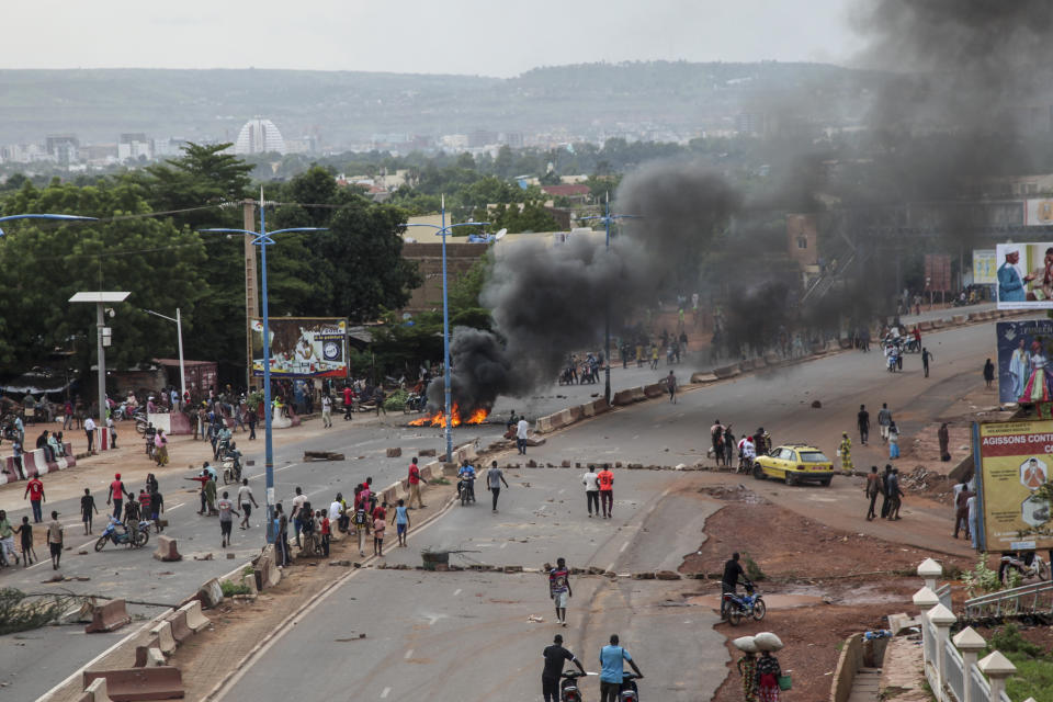 Anti-government protesters burn tires and barricade roads in the capital Bamako, Mali, Friday, July 10, 2020. Thousands marched Friday in Mali's capital in anti-government demonstrations urged by an opposition group that rejects the president's promises of reforms. (AP Photo/Baba Ahmed)