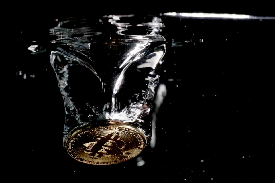 A visual representation of the digital currency Bitcoin sinks into water on August 15, 2018 in London, England.