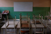 Empty desks are seen in the classroom on the first day of school, in Caucagua, Venezuela September 17, 2018. REUTERS/Marco Bello