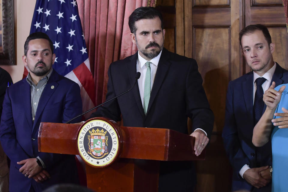 FILE - In this July 16, 2019 file photo, Puerto Rico Gov. Ricardo Rossello, accompanied by his chief of staff Ricardo Llerandi, right, attends a press conference in La Fortaleza's Tea Room, in San Juan, Puerto Rico. Llerandi announced his resignation Tuesday, July 23, 2019, saying; "The last few days have been extremely difficult for everyone," At this historic crossroads, I need to put my family above everything." Pictured left is Erik Rolon, undersecretary of the interior. (AP Photo/Carlos Giusti, File)