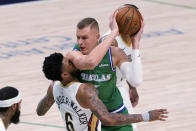 New Orleans Pelicans guard Nickeil Alexander-Walker (6) takes an arm to the face while defending against Dallas Mavericks center Kristaps Porzingis during the first half of an NBA basketball game in Dallas, Wednesday, May 12, 2021. (AP Photo/Tony Gutierrez)