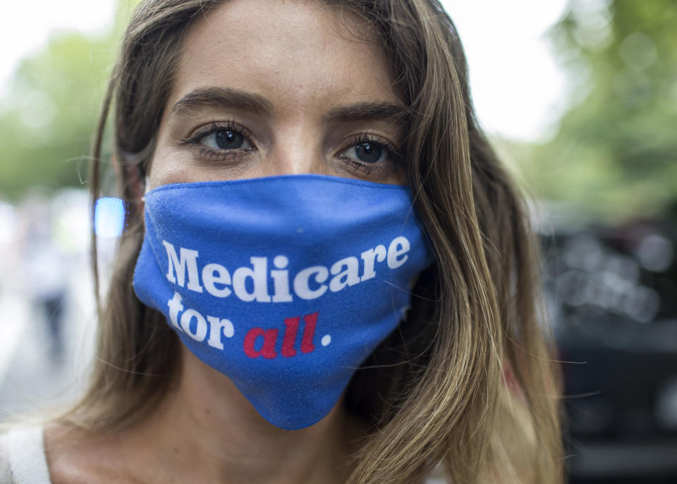 A woman wearing a face mask with Medicare for All written on it takes part in the March for Medicare for All in Washington D.C. (Photo by Probal Rashid/LightRocket via Getty Images)