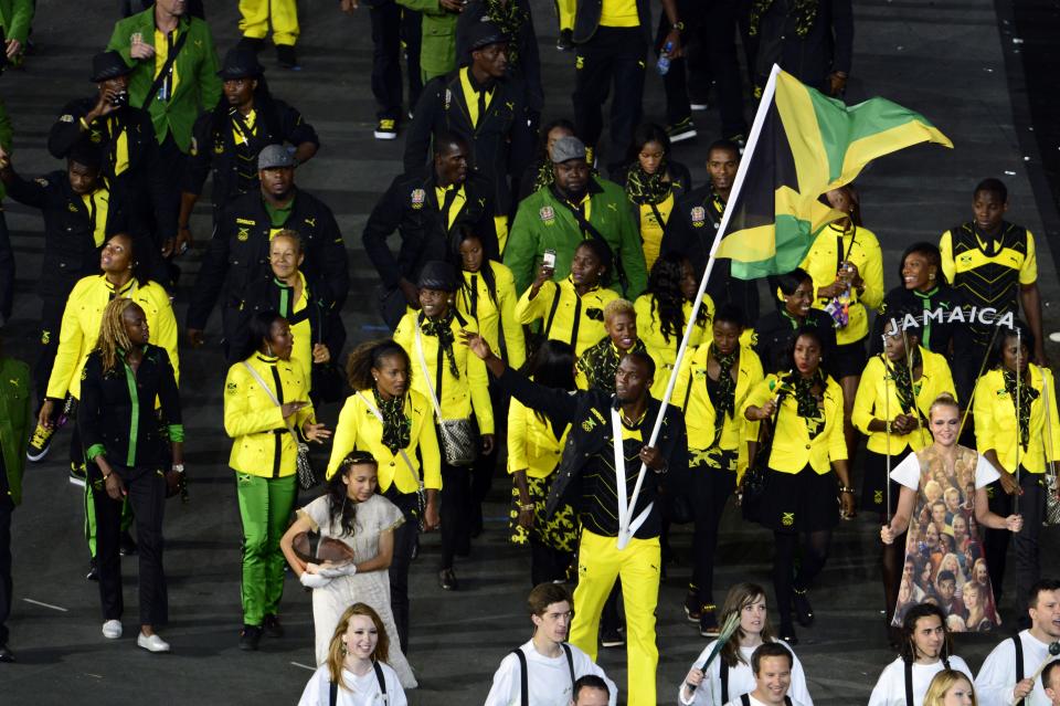 Jamaica's flagbearer Usain Bolt leads his delegation during the opening ceremony of the London 2012 Olympic Games in the Olympic Stadium in London on July 27, 2012.  AFP PHOTO / JOHN MACDOUGALL        (Photo credit should read JOHN MACDOUGALL/AFP/GettyImages)