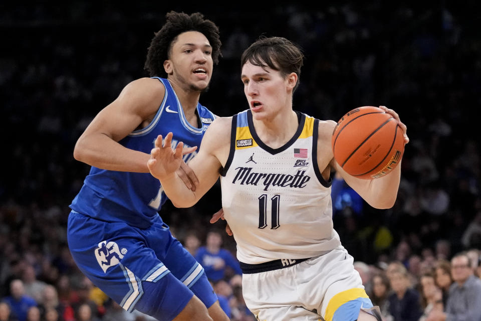 Marquette's Tyler Kolek (11) drives past Xavier's Desmond Claude (1) in the second half of an NCAA college basketball game for the championship of the Big East men's tournament, Saturday, March 11, 2023, in New York. (AP Photo/John Minchillo)