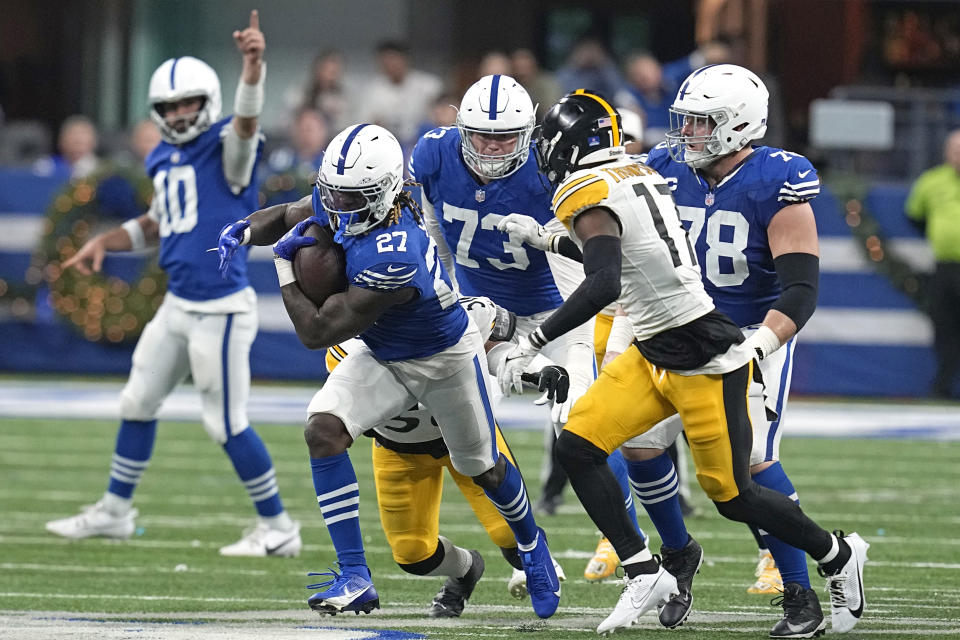 Indianapolis Colts running back Trey Sermon (27) carries the ball with Pittsburgh Steelers safety Trenton Thompson (17) defending during the second half of an NFL football game in Indianapolis Saturday, Dec. 16, 2023. (AP Photo/Darron Cummings)