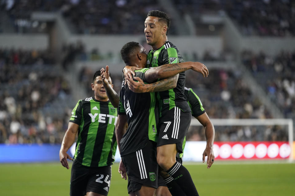 Austin FC defender Nick Lima (24), defender Ruben Gabrielsen (4), and defender Julio Cascante (18) celebrate after Gabrielsen scored a goal during the first half of an MLS soccer match against the Los Angeles FC in Los Angeles, Wednesday, May 18, 2022. (AP Photo/Ashley Landis)