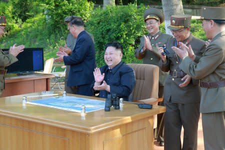 FILE PHOTO : North Korean leader Kim Jong Un inspects the intermediate-range ballistic missile Pukguksong-2's launch test with Ri Pyong Chol (2nd L in black uniform) and Jang Chang Ha (R) in this undated photo released by North Korea's Korean Central News Agency (KCNA) May 22, 2017. REUTERS/KCNA/File Photo