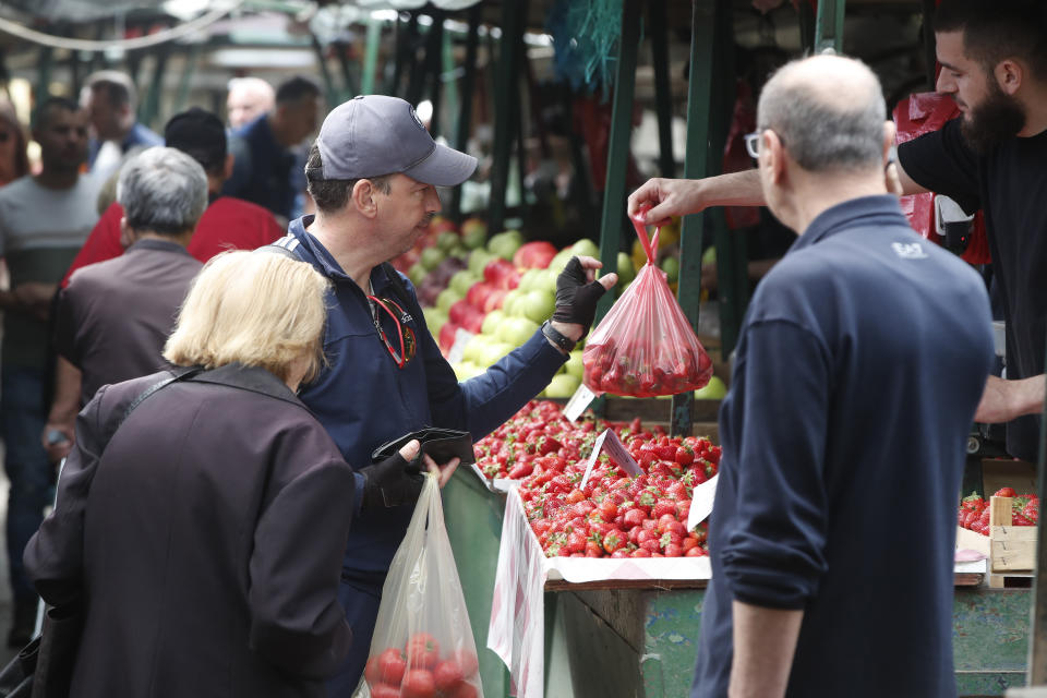 People buy strawberries in a green market in Skopje, North Macedonia, on Monday, May 6, 2024. Voters go to the polls on Wednesday in North Macedonia to cast ballots for parliamentary election and presidential runoff, for the second time in two weeks. (AP Photo/Boris Grdanoski)