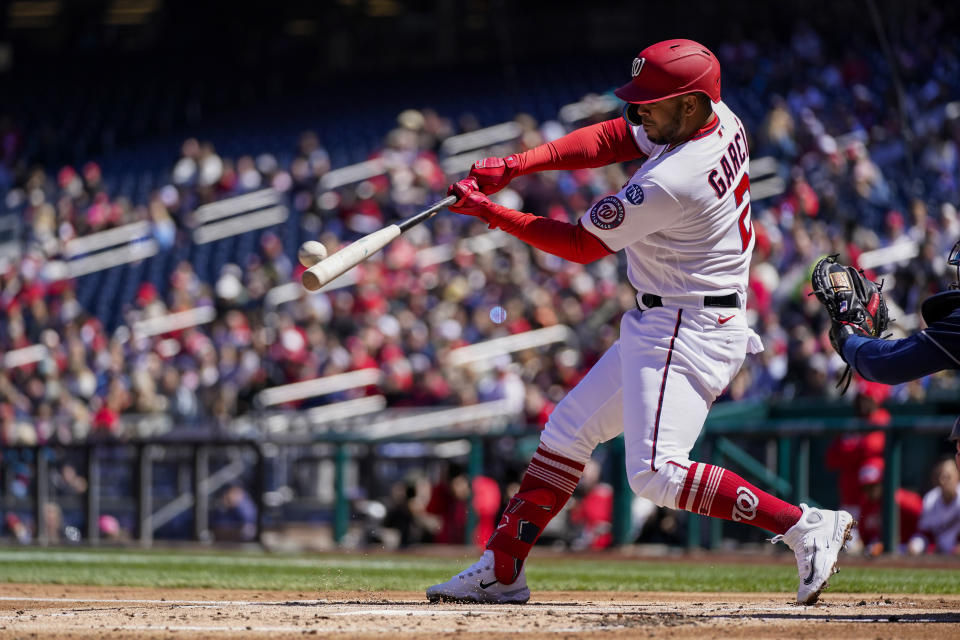 Washington Nationals' Luis Garcia hits a sacrifice fly to score a run during the first inning of a baseball game against the Atlanta Braves at Nationals Park, Sunday, April 2, 2023, in Washington. (AP Photo/Alex Brandon)