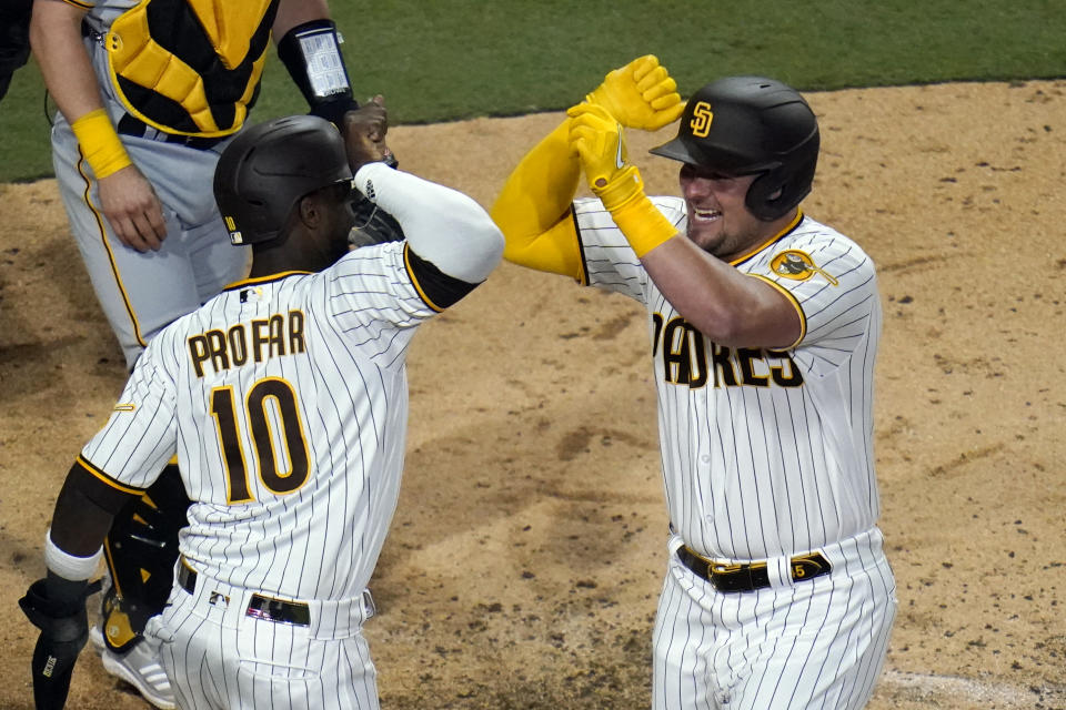 San Diego Padres' Luke Voit, right, celebrates with Jurickson Profar (10) after hitting a three-run home run against the Pittsburgh Pirates during the sixth inning of a baseball game Friday, May 27, 2022, in San Diego. (AP Photo/Gregory Bull)