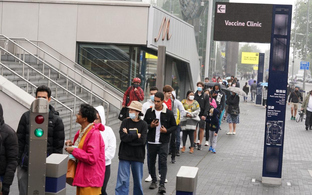 Hundreds queue outside a pop-up vaccination clinic at Tottenham Hotspur's stadium in North London - PA