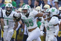 Marshall defensive lineman Owen Porter (55) celebrates an interception against Notre Dame during the second half of an NCAA college football game in South Bend, Ind., Saturday, Sept. 10, 2022. Marshall defeated Notre Dame 26-21. (AP Photo/Michael Conroy)